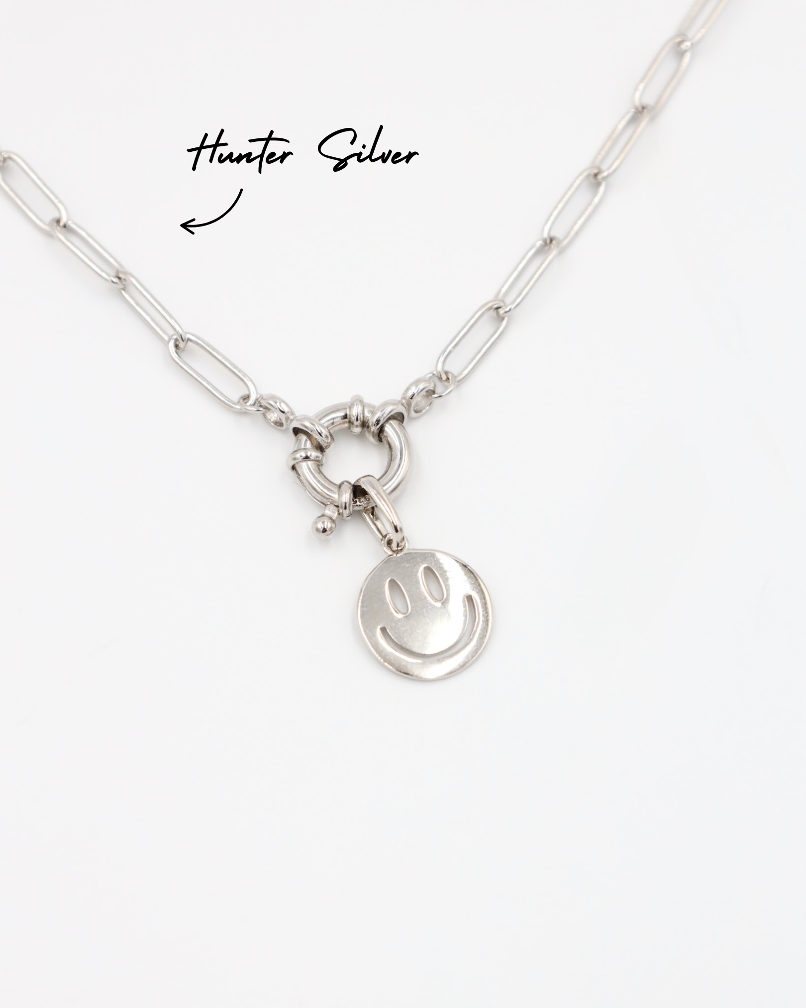 Flynn Silver smiley face pendant hanging on the Hunter Silver chain, both made of rhodium-plated 925 sterling silver.