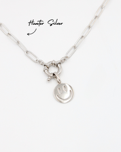 Flynn Silver smiley face pendant hanging on the Hunter Silver chain, both made of rhodium-plated 925 sterling silver.