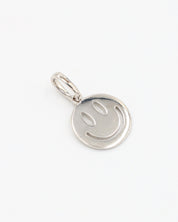 Flynn Silver pendant, a smiley face design crafted from rhodium-plated 925 sterling silver, displayed at an angle.