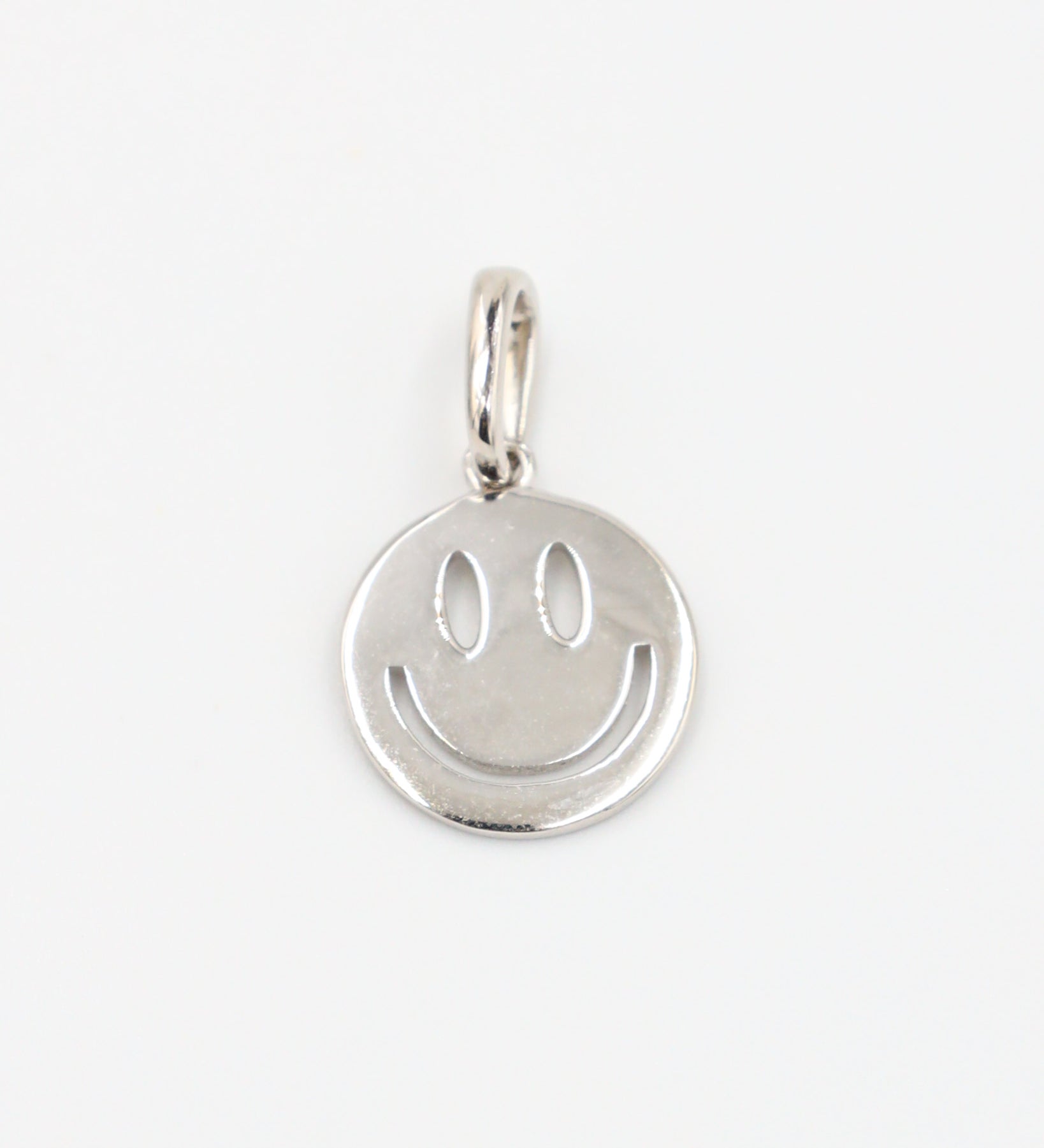 Flynn Silver pendant featuring a smiley face design crafted from rhodium-plated 925 sterling silver, shown from the front.