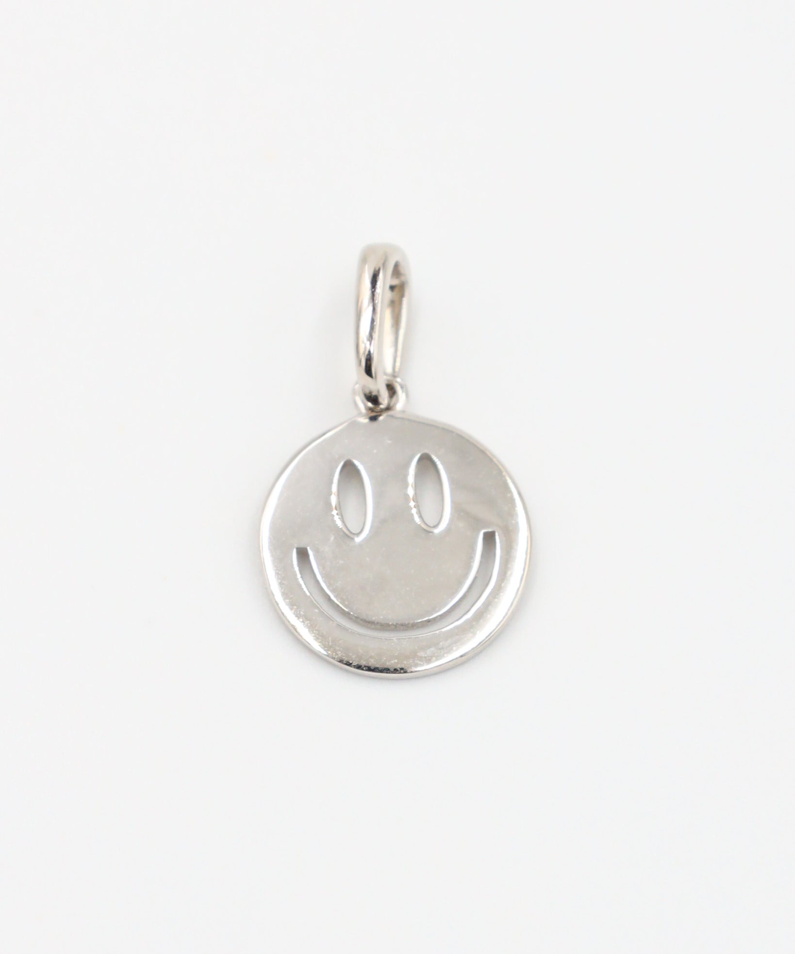 Flynn Silver pendant featuring a smiley face design crafted from rhodium-plated 925 sterling silver, shown from the front.