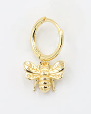 Single gold-plated sterling silver hoop earring with a bee charm, side view.