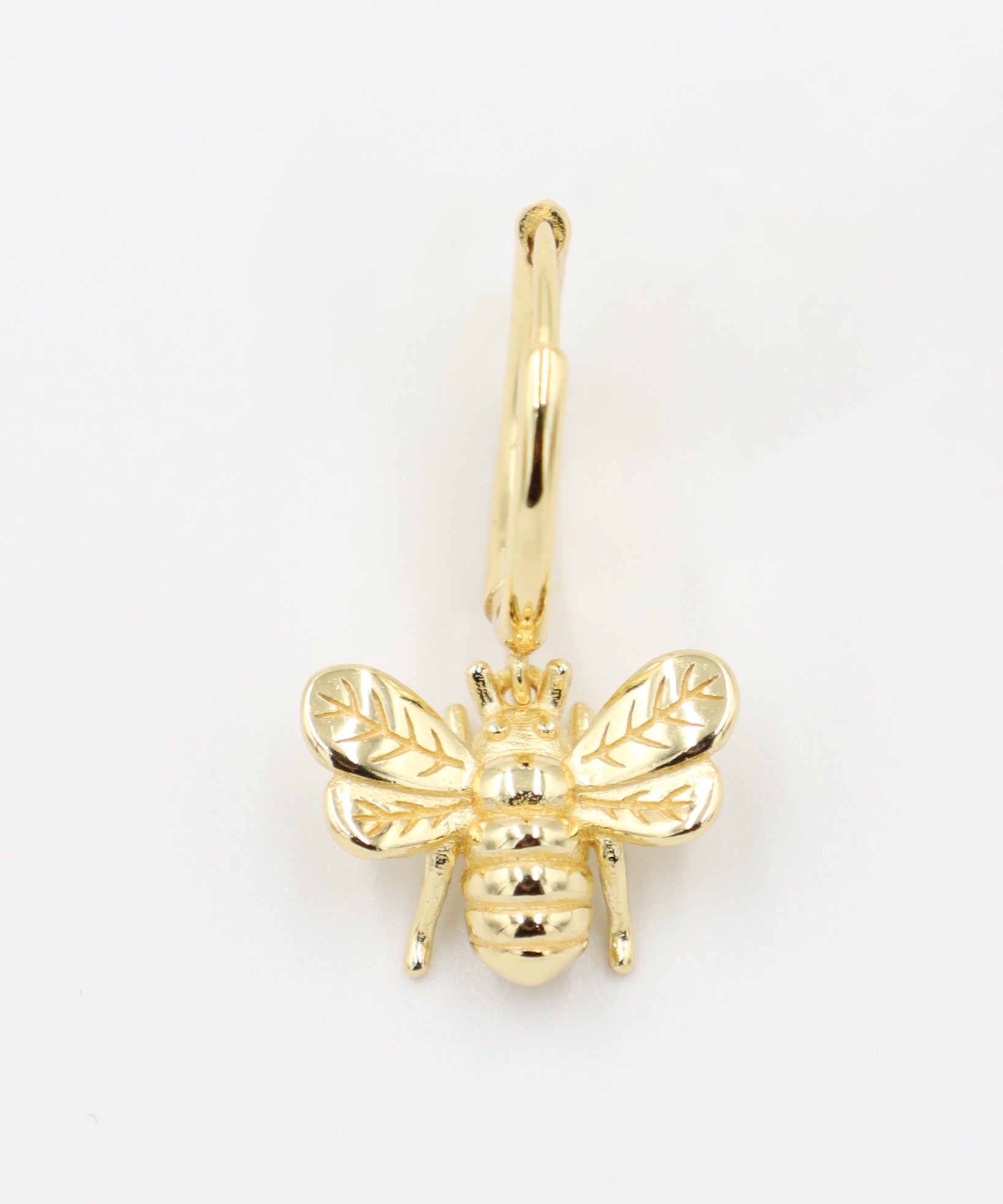 Single gold-plated sterling silver hoop earring featuring a detailed bee charm, front view.