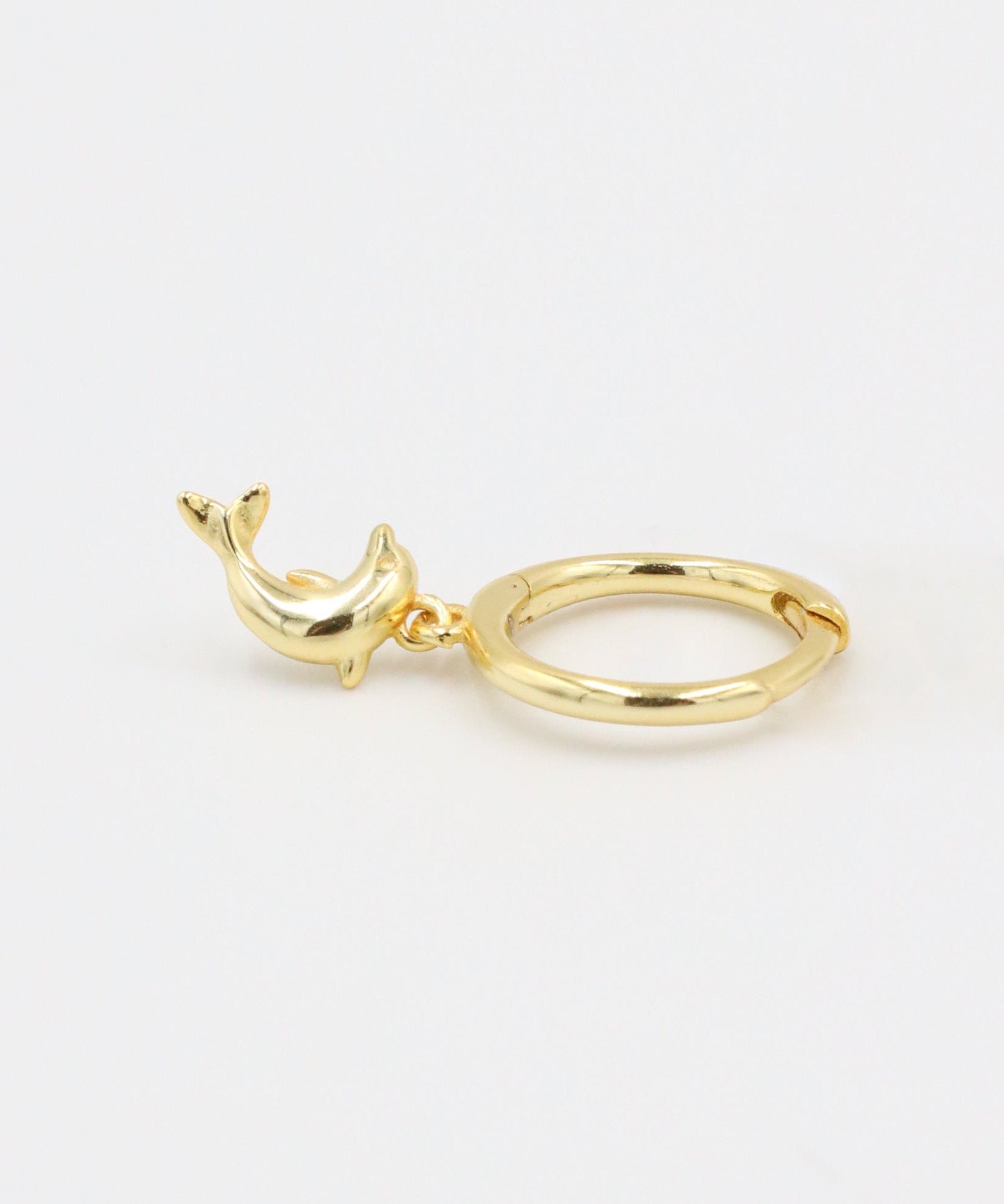 Single gold-plated sterling silver hoop earring with dolphin charm, left ear.
