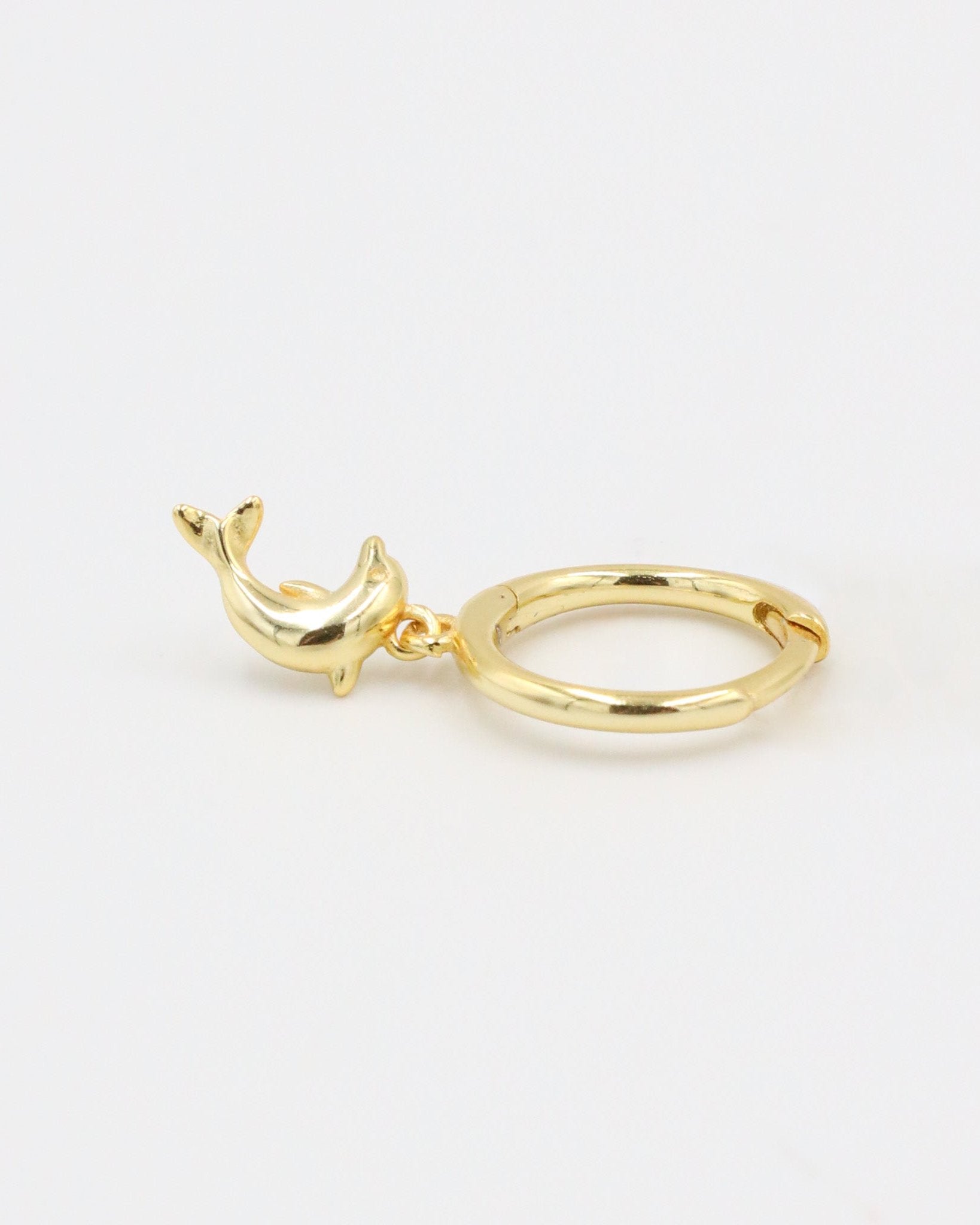 Single gold-plated sterling silver hoop earring with dolphin charm, left ear.
