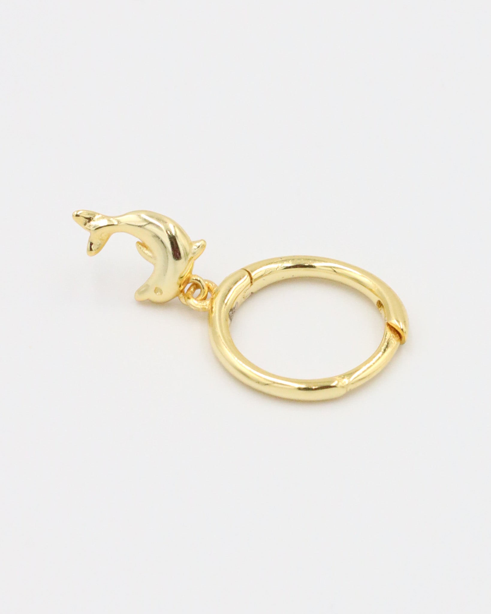 Single gold-plated sterling silver hoop earring with dolphin charm, right ear.
