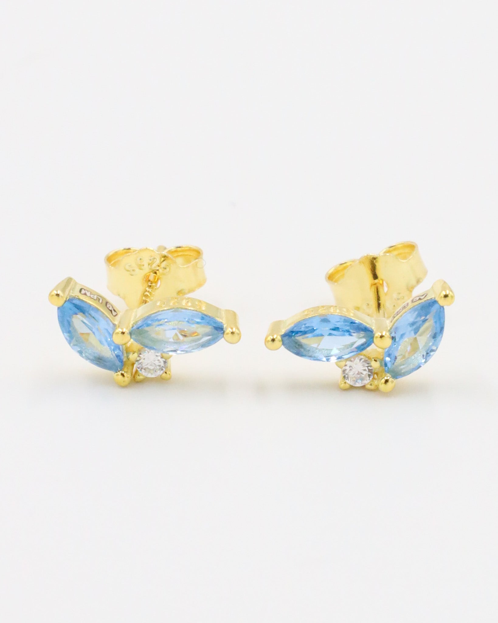 Pair of gold-plated sterling silver stud earrings with two blue zirconia stones in a marquise cut and a central round zirconia stone.