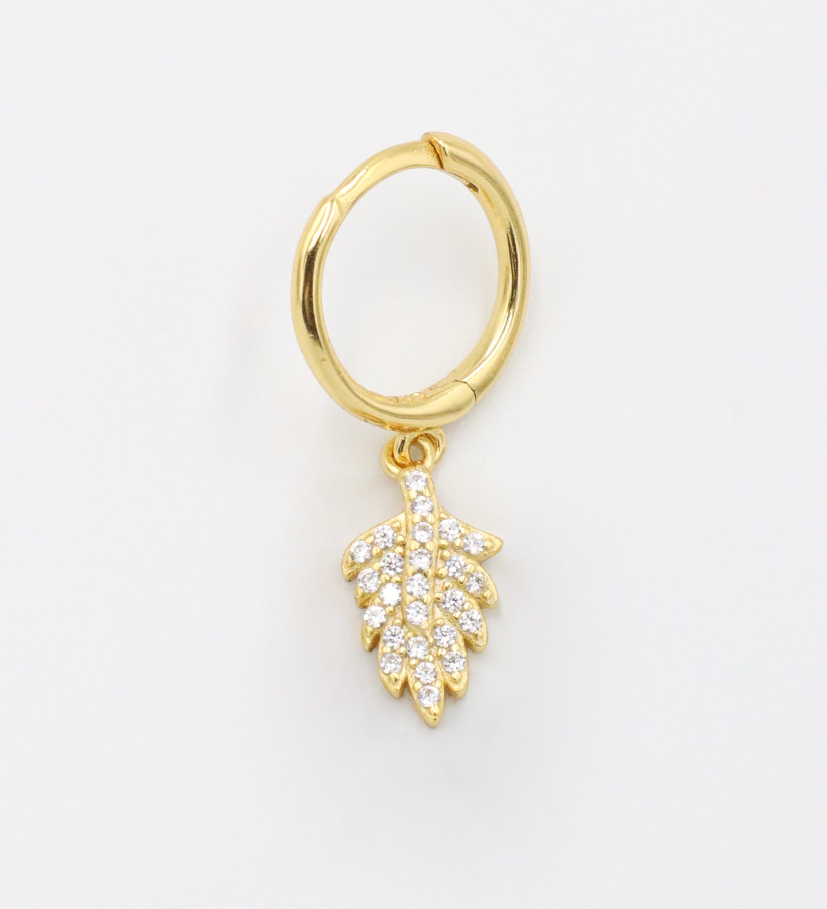 Gold-plated sterling silver hoop earring with leaf design and zirconia stones, front view