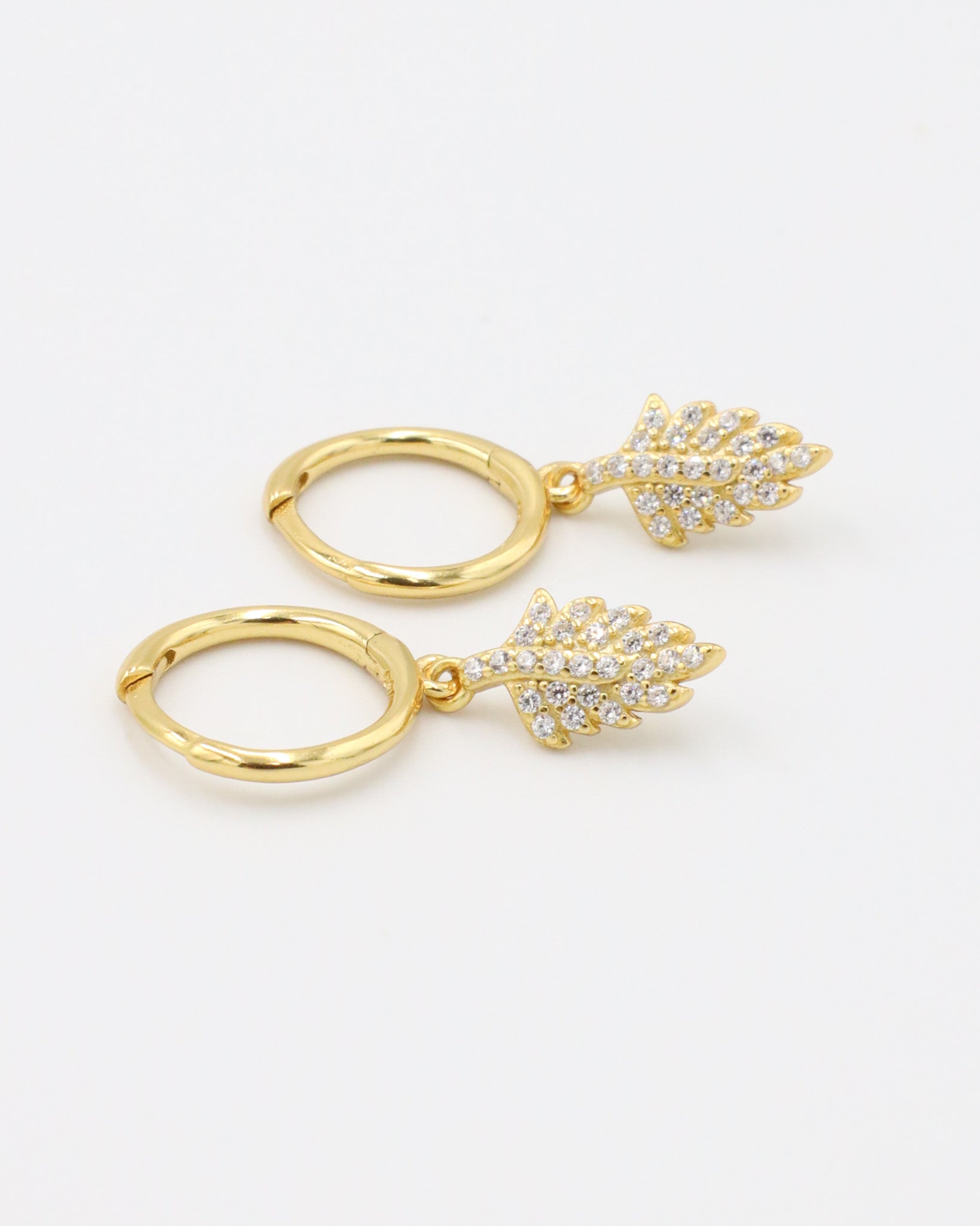 Pair of gold-plated sterling silver hoop earrings with leaf design and zirconia stones