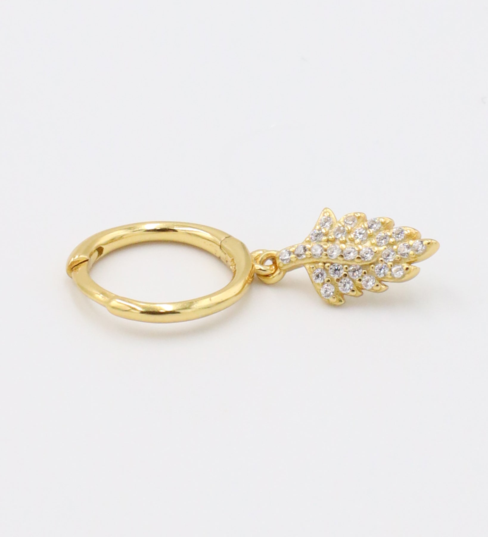 Gold-plated sterling silver hoop earring with leaf design and zirconia stones, side view