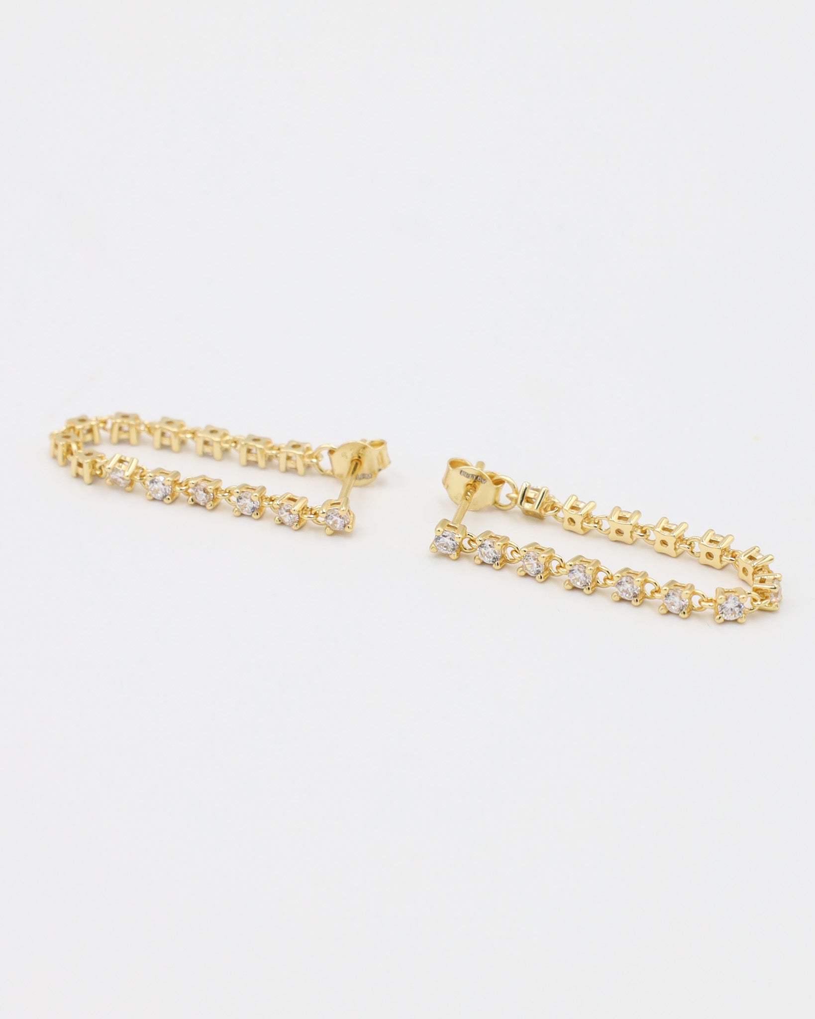 A pair of Shannon stud earrings in gold-plated sterling silver with sparkling zirconia stones.