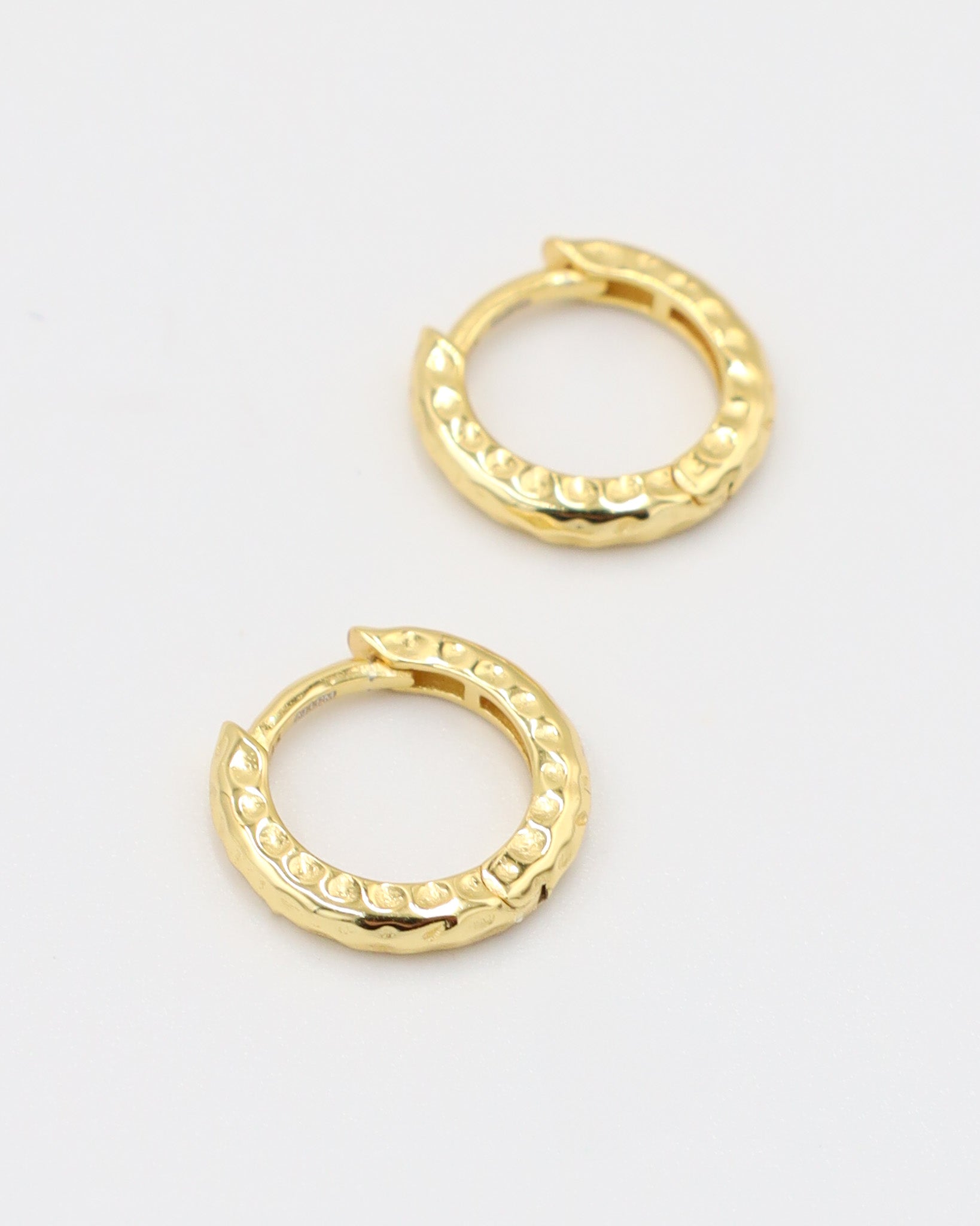 Gold-plated sterling silver Siranush huggie earrings, shown as a pair, featuring a textured design.