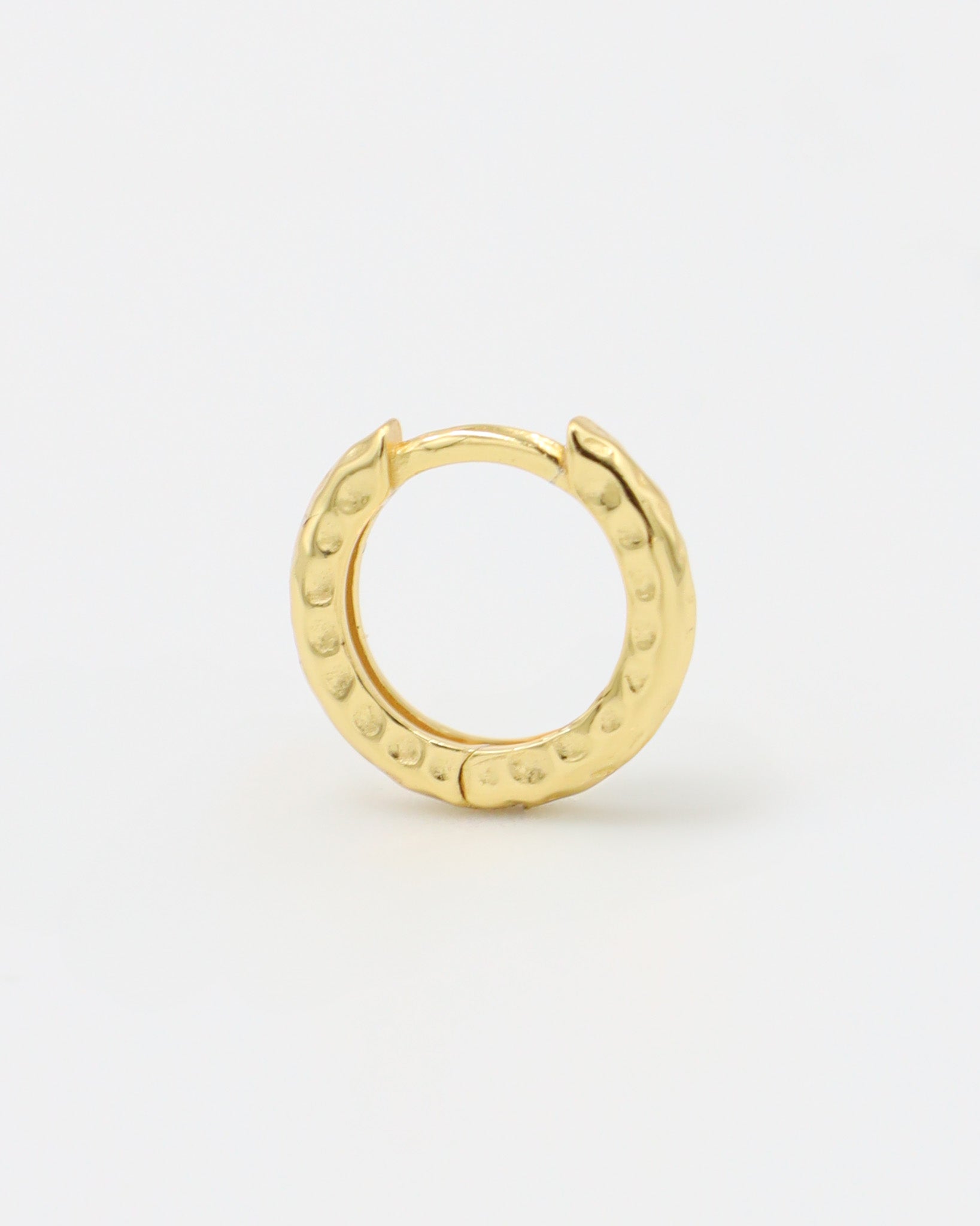 Single gold-plated sterling silver Siranush huggie earring, highlighting its detailed craftsmanship.