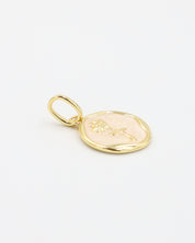 Close-up of the Gwendolyn Gold pendant with an elegant flower motif in enamel, crafted from gold-plated 925 sterling silver.