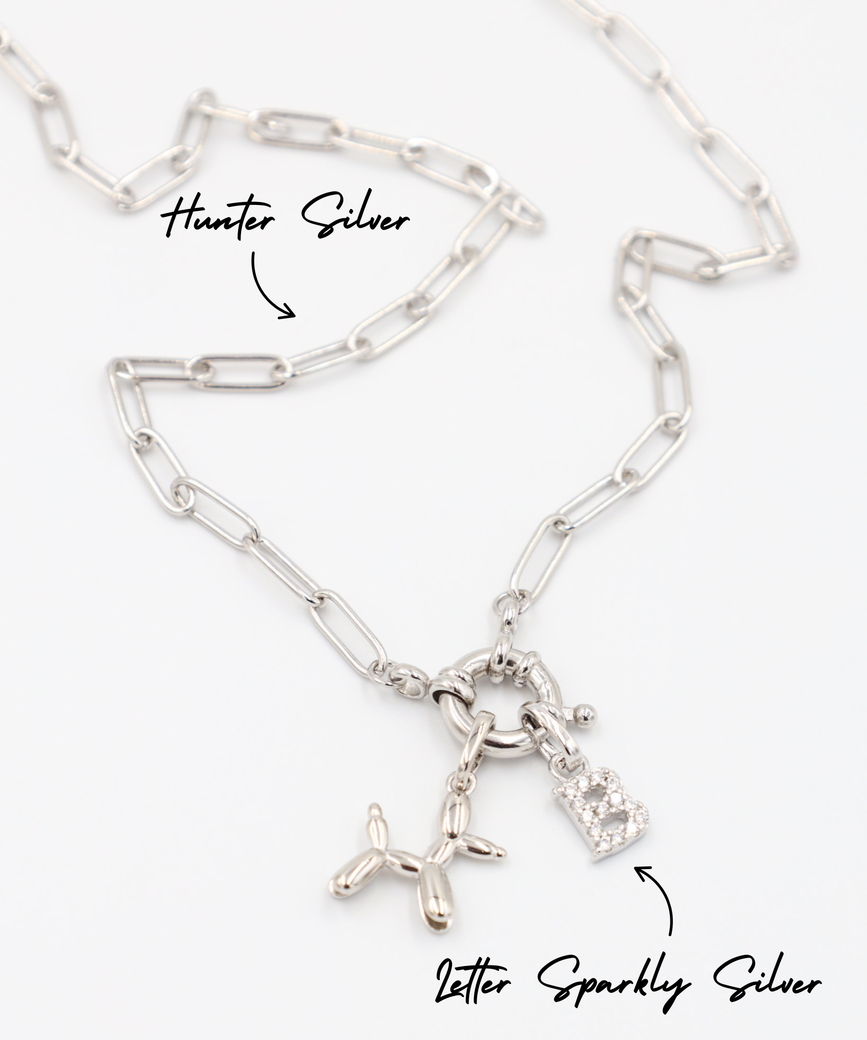 Close-up view of the Hunter Silver necklace in 925 sterling silver, featuring the Balloon Dog Silver pendant and the Letter Sparkly Silver pendant.