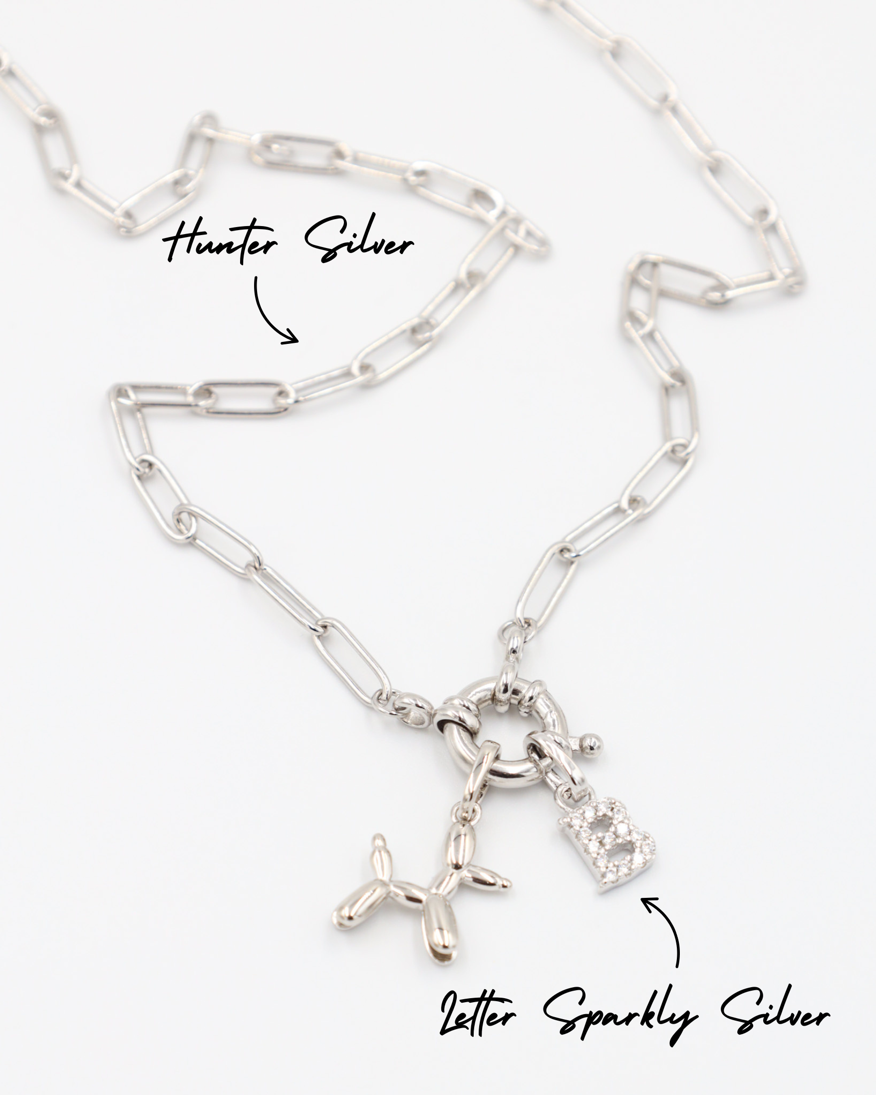 Close-up view of the Hunter Silver necklace in 925 sterling silver, featuring the Balloon Dog Silver pendant and the Letter Sparkly Silver pendant.