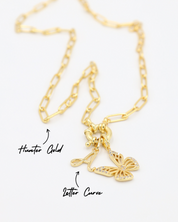 Hunter Gold chain necklace featuring a combination of the Letter Curve "A" pendant and the Butterfly Gold pendant with zirconia stones, all in gold-plated 925 sterling silver.