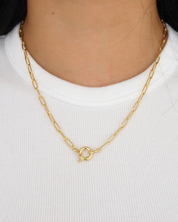 Gold-plated Hunter necklace with clasp worn on model's neck.