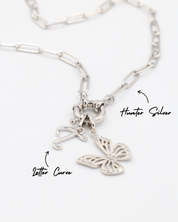 Hunter Silver necklace featuring a Butterfly Silver pendant and a letter curve charm, both in rhodium-plated 925 sterling silver.