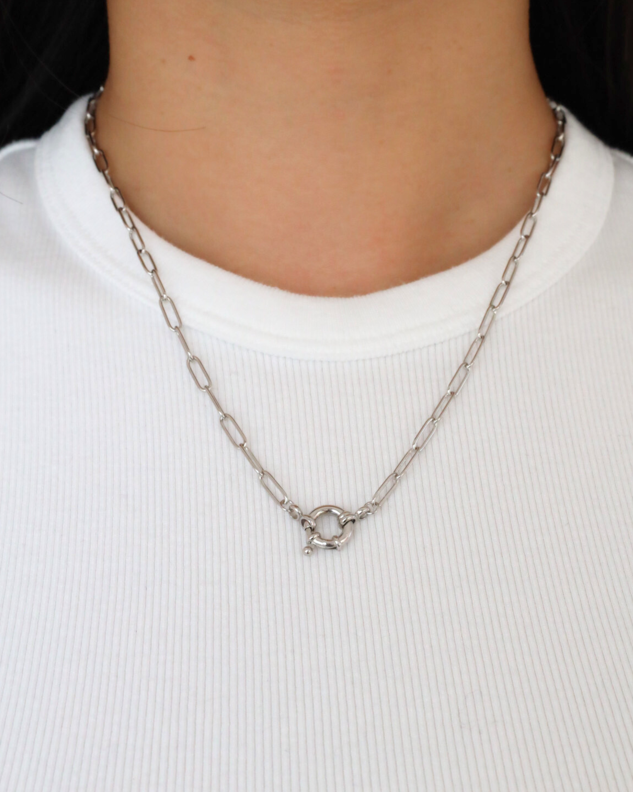 The Hunter Necklace in 925 sterling silver displayed on a person, showcasing its minimalist design and circular clasp.