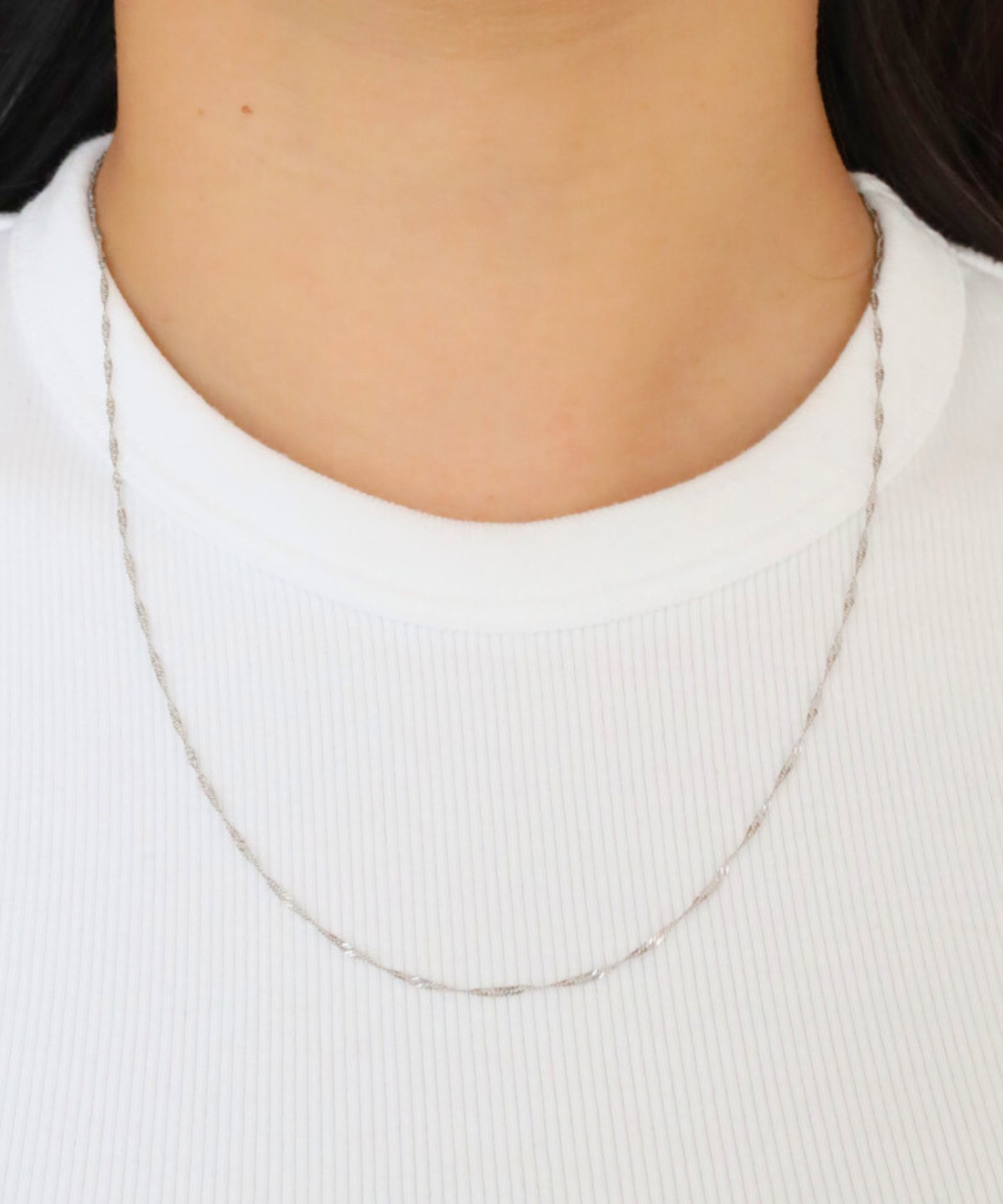 Woman wearing the delicate Jamie Silver necklace, made from 925 sterling silver.