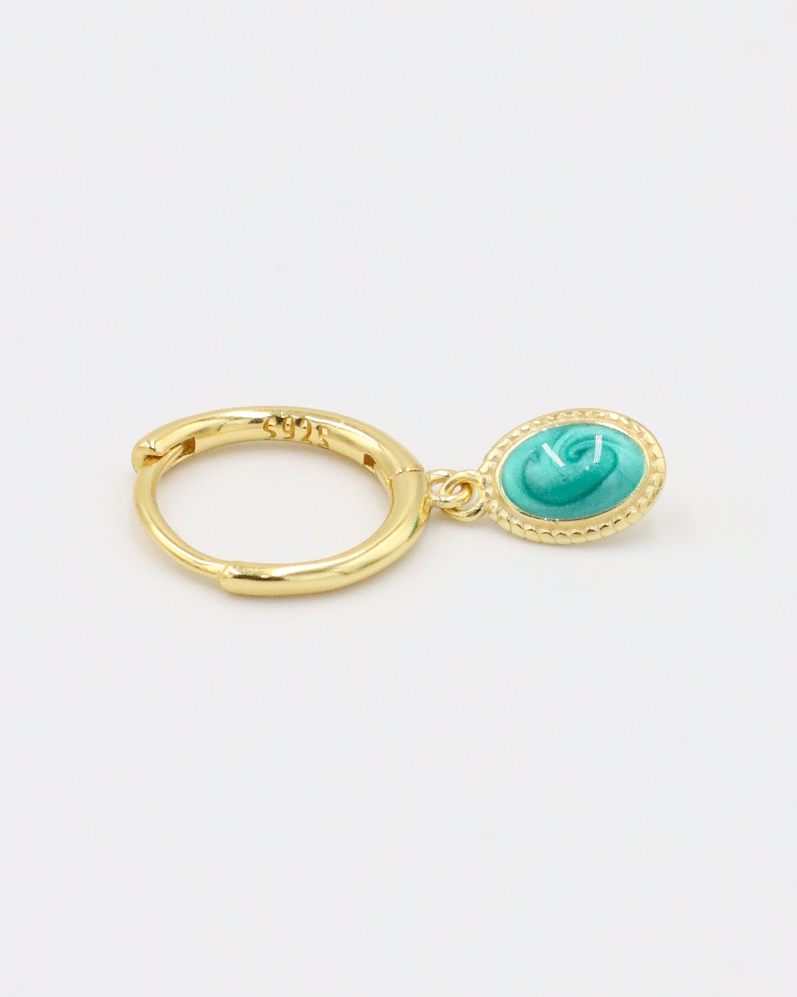 A single gold-plated sterling silver hoop earring with an oval turquoise charm, viewed from the side.
