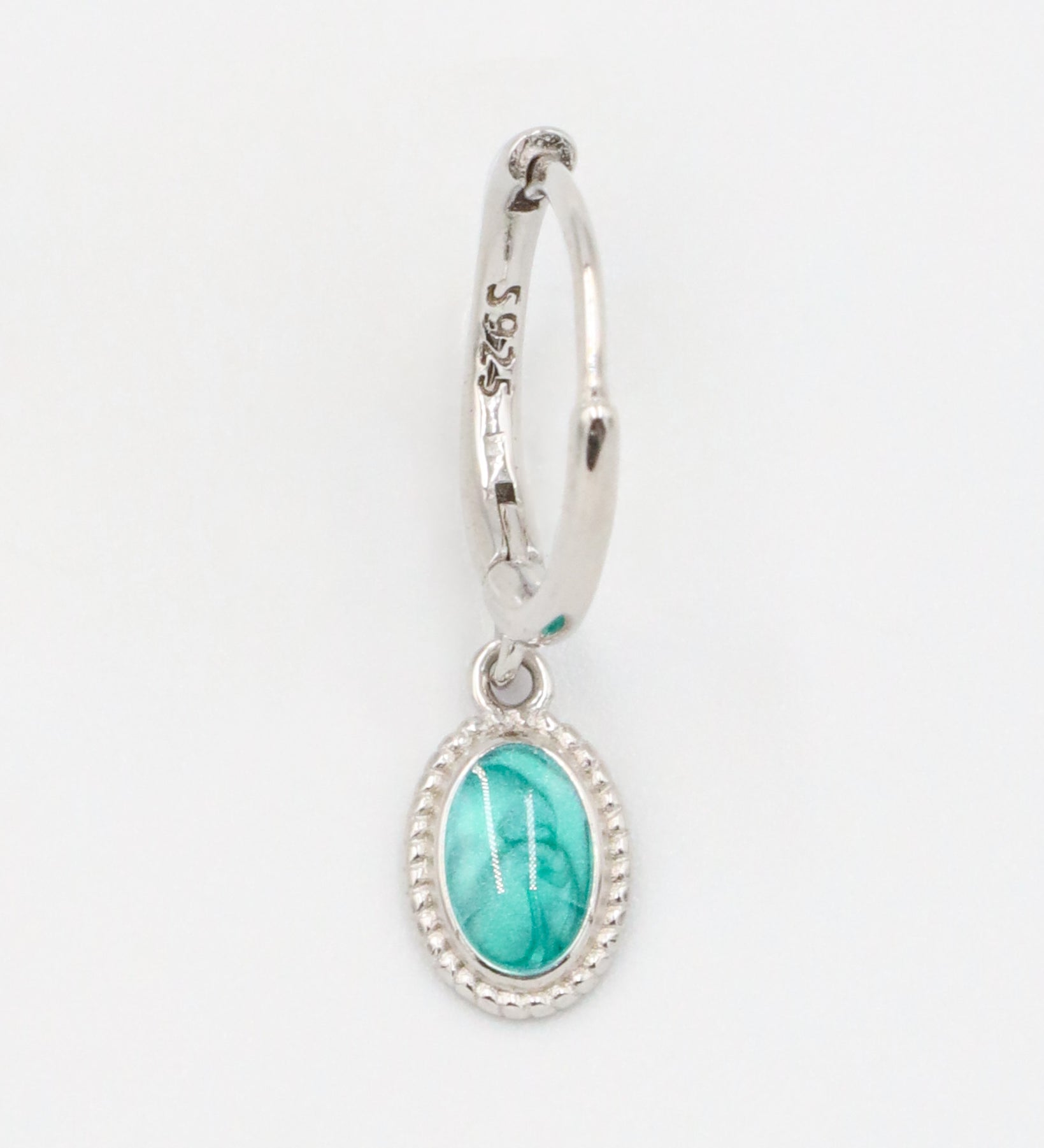 Single Josefine Silver hoop earring with a turquoise oval pendant on a sterling silver hoop.
