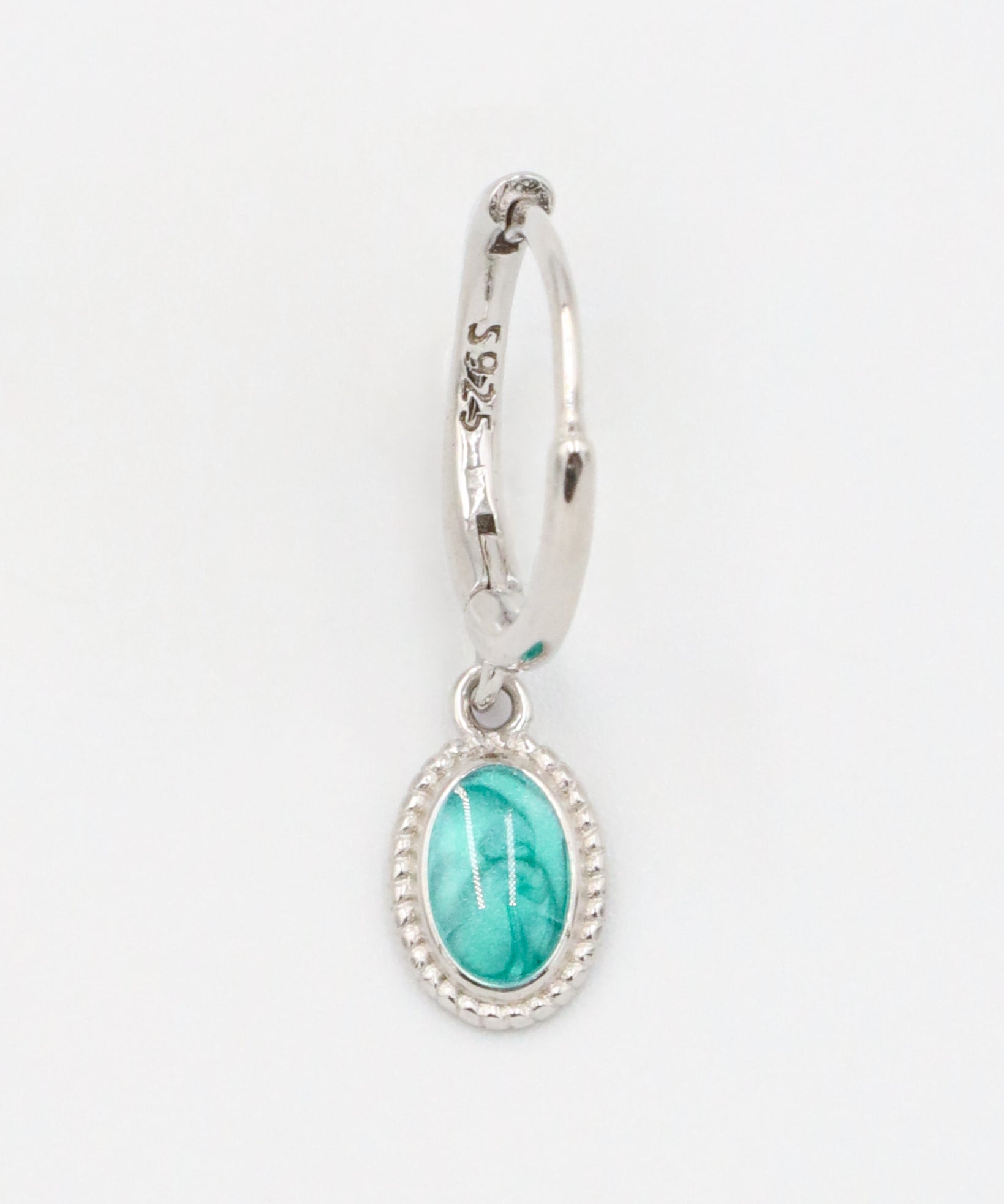 Single Josefine Silver hoop earring with a turquoise oval pendant on a sterling silver hoop.
