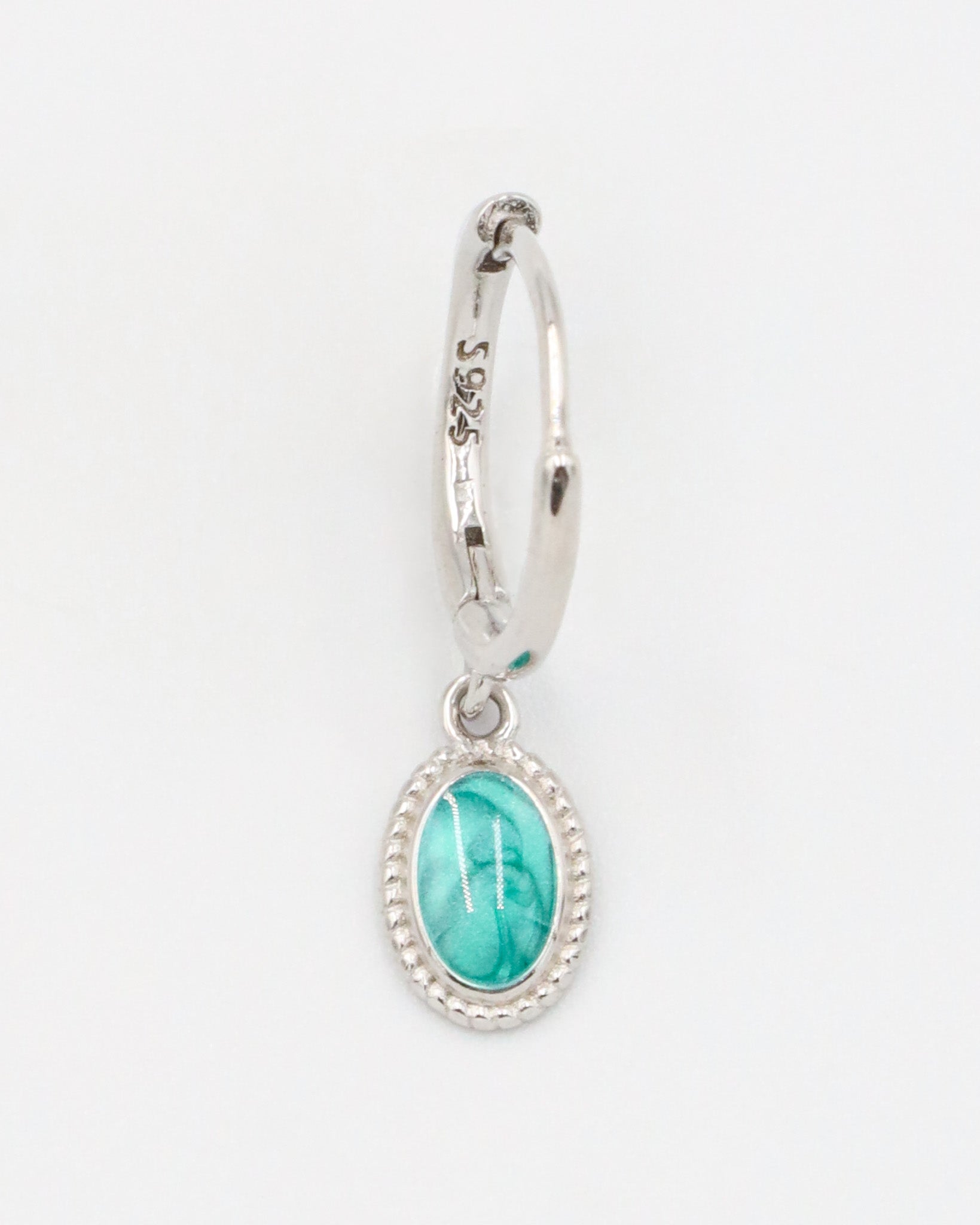 Single Josefine Silver hoop earring with a turquoise oval pendant on a sterling silver hoop.
