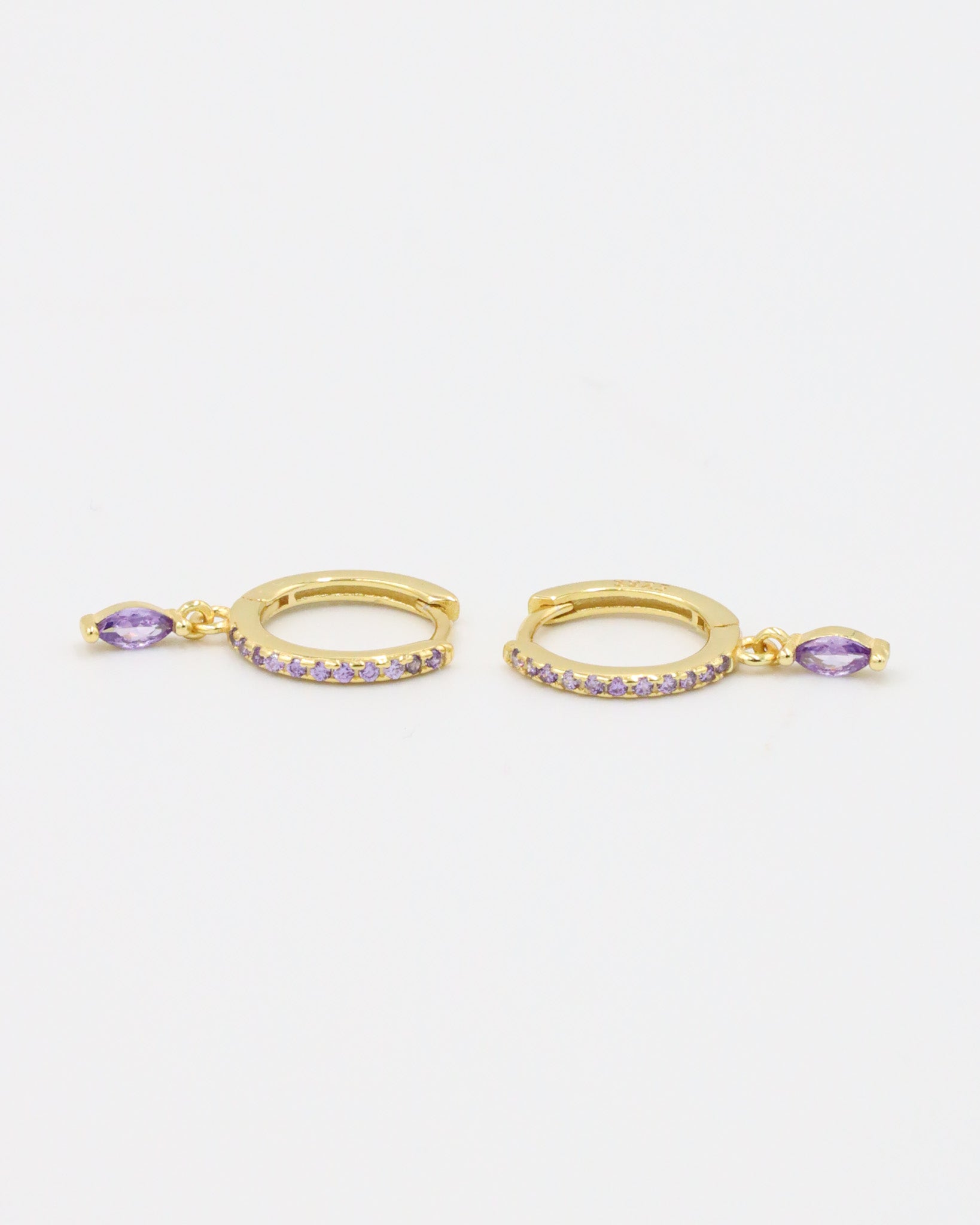 A pair of Kyiomi Purple earrings made from gold-plated sterling silver, featuring small purple zirconia stones along the hoop and a dangling marquise-shaped purple zirconia stone.