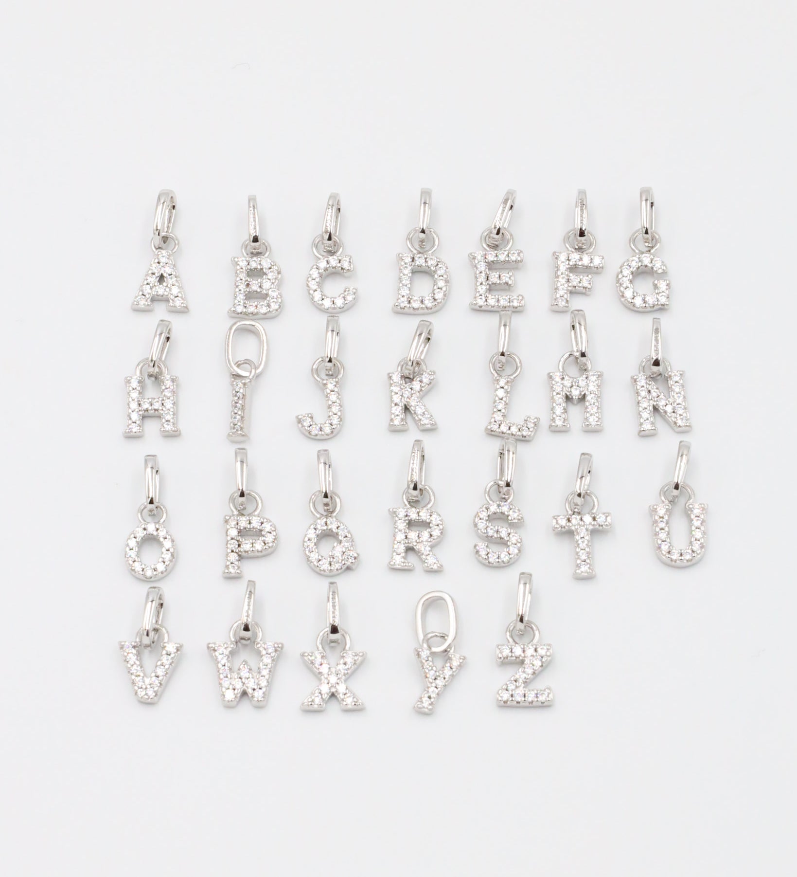Personalized sterling silver letter pendants with zirconia.
