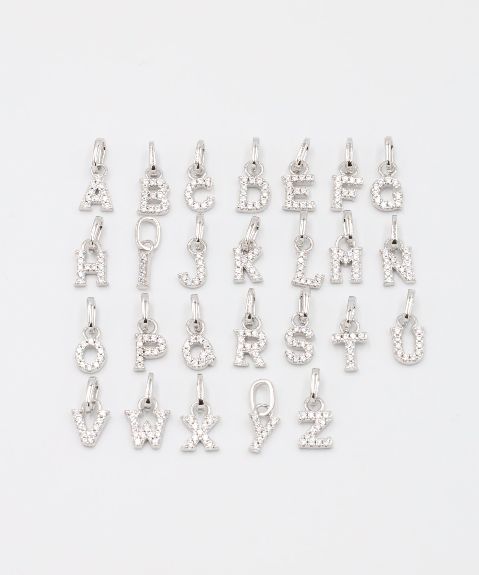 Personalized sterling silver letter pendants with zirconia.