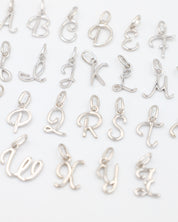 Rhodium plated 925 sterling silver letter curve pendants from A to Z, displayed in a grid layout.