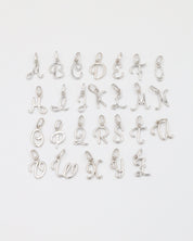 Full set of rhodium plated 925 sterling silver letter curve pendants displayed in alphabetical order.
