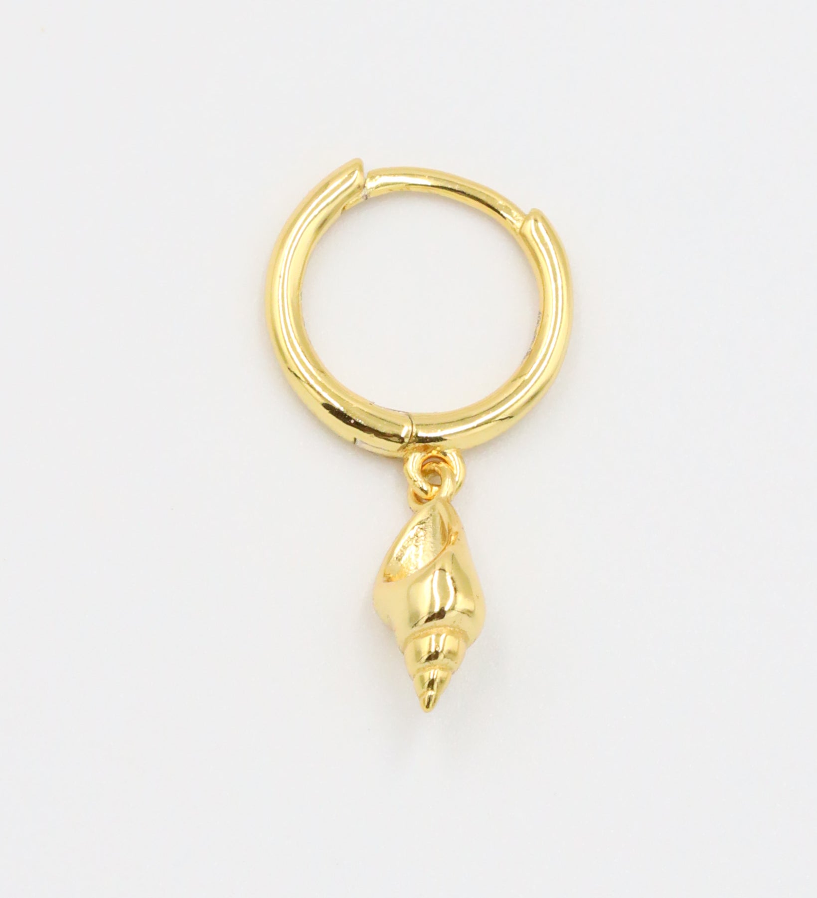 A close-up of a single "Maddy" earring, showing the intricate design of the seashell charm, crafted from gold-plated 925 sterling silver.
