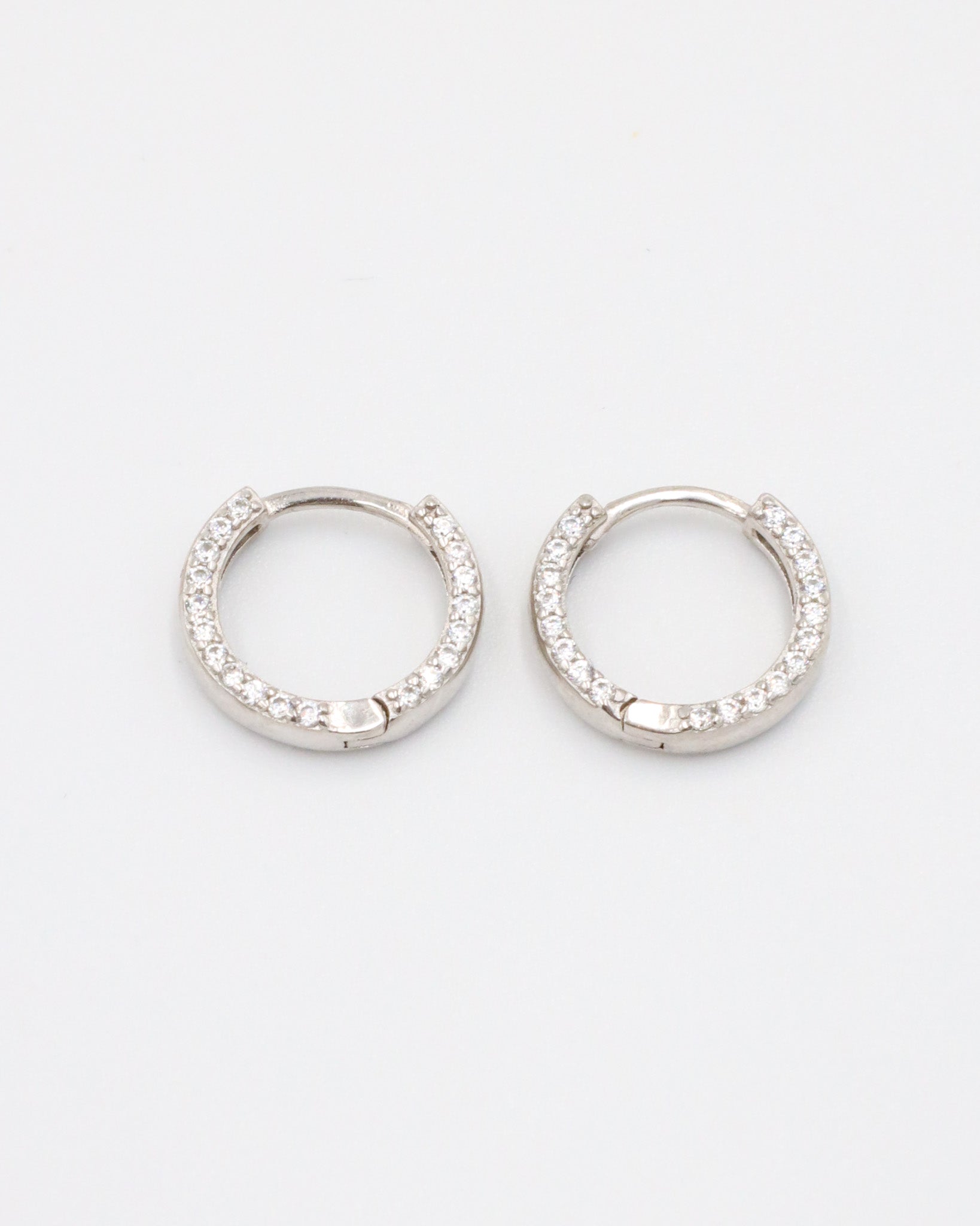 Elegant Mara sterling silver hoop earrings encrusted with shimmering zirconia stones, a versatile and timeless staple.