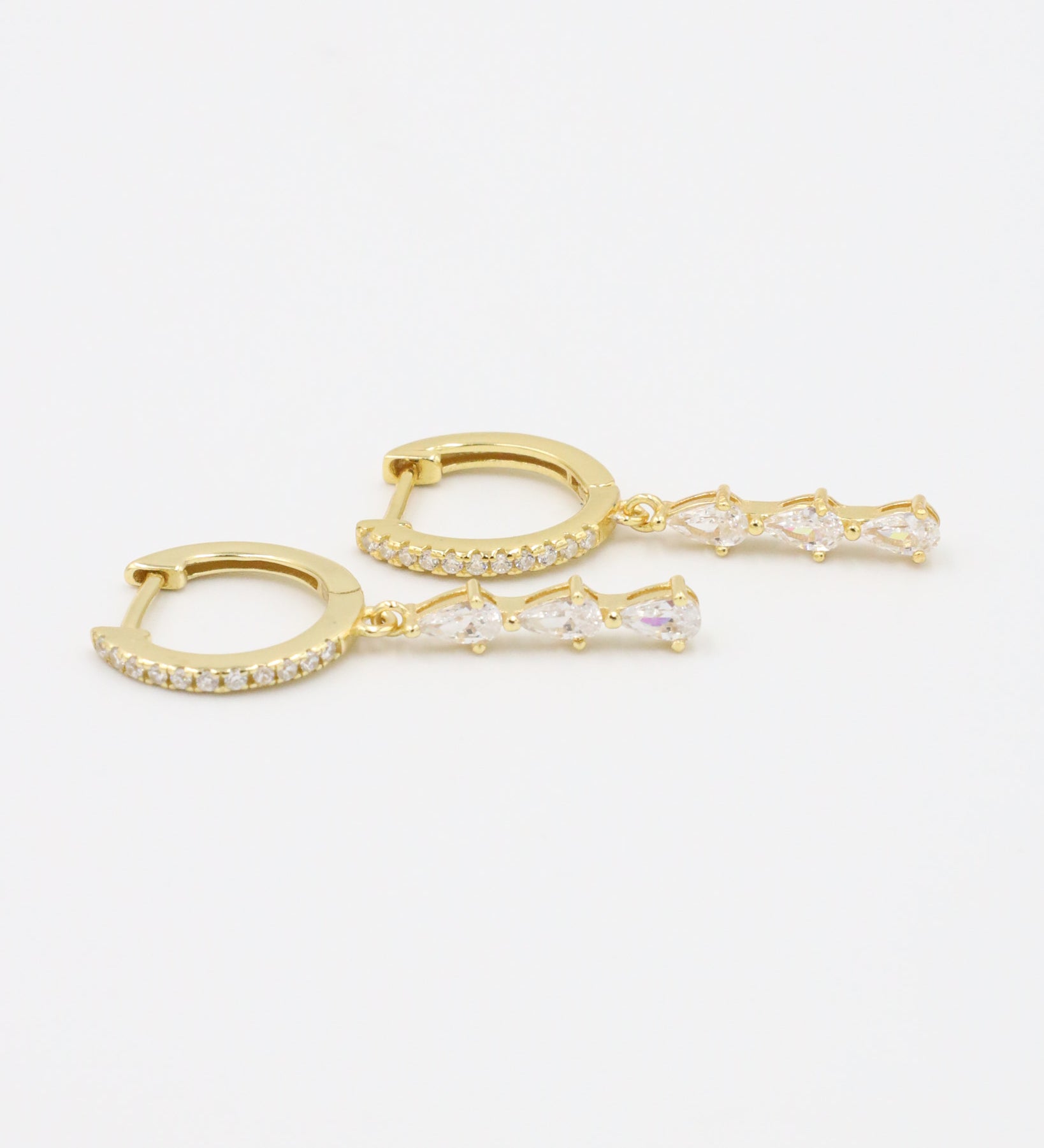 Micah gold drop earring with four teardrop-shaped zirconia stones and pavé hoop, front view.