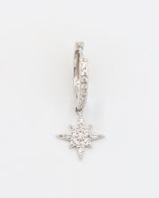 A single "Nova Silver" earring made from sterling silver, featuring cubic zirconia stones arranged in a star-shaped pendant with pave detailing on the hoop.