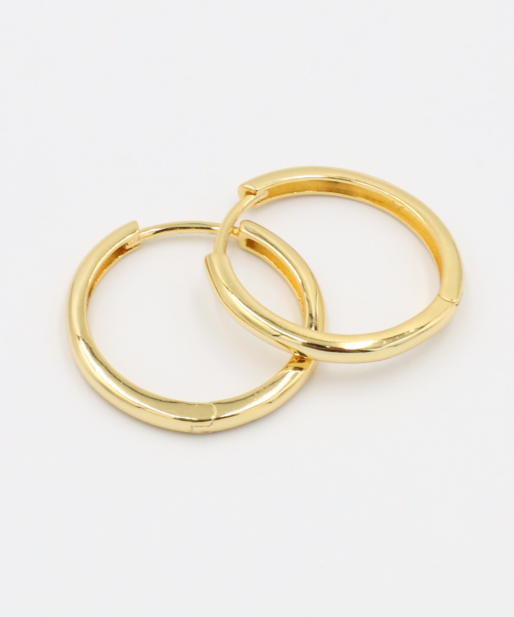 Rachele hoop earring pair made from gold-plated sterling silver, shown flat to highlight the polished finish.