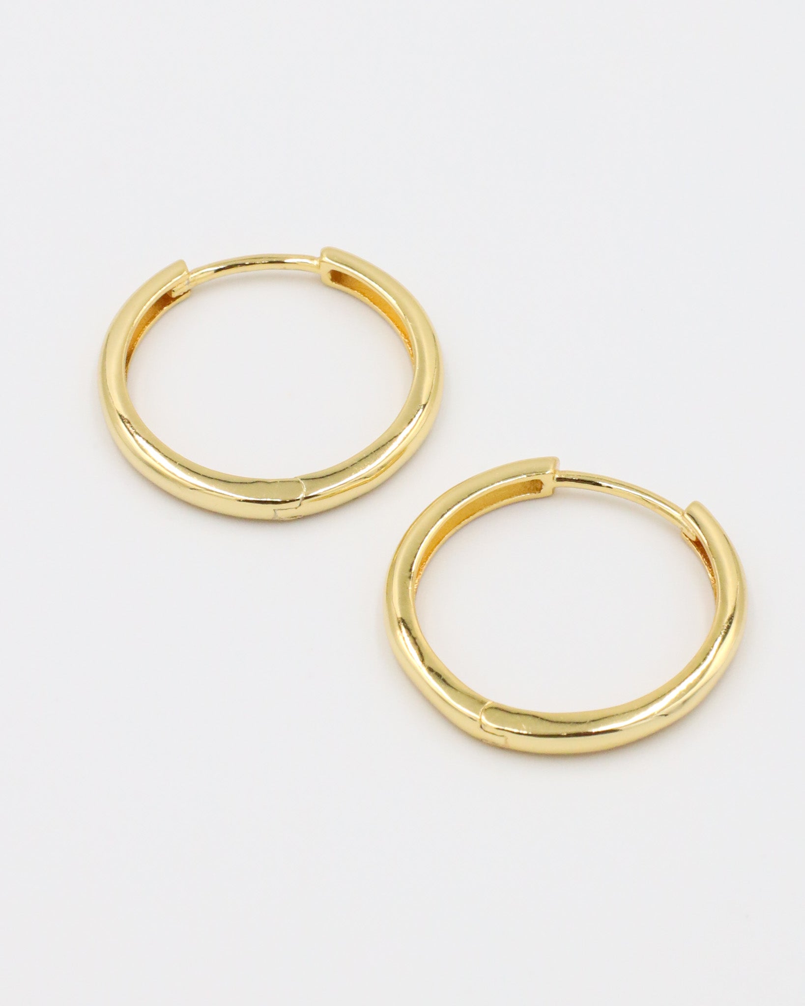 Side view of Rachele hoop earrings, crafted from gold-plated sterling silver, showing the classic hoop shape.