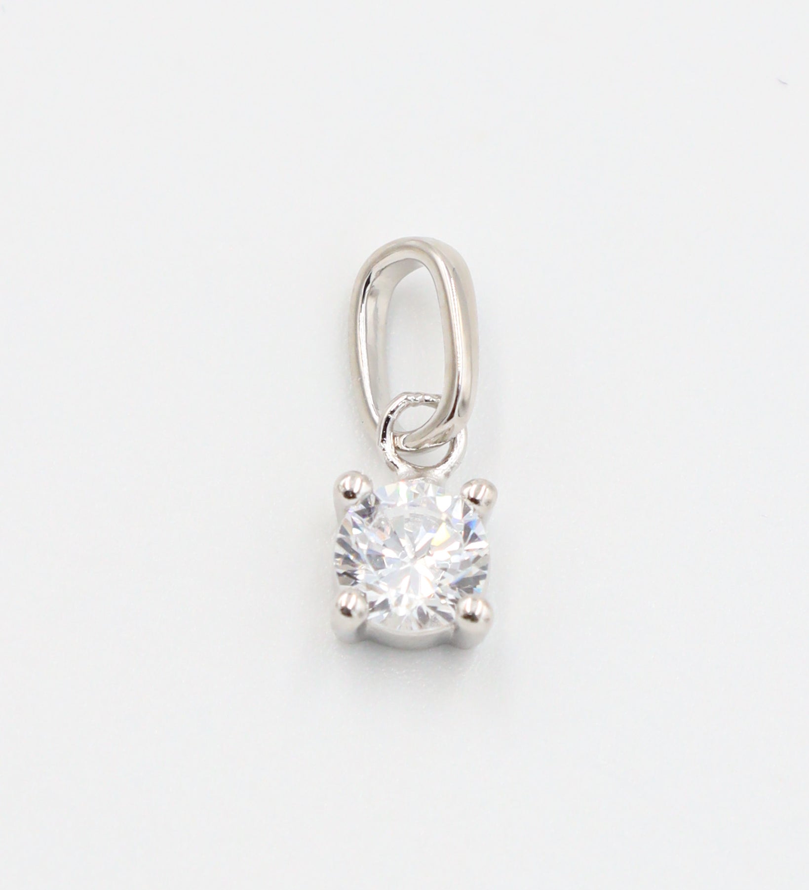 A close-up view of the Riley Silver pendant showcasing the sparkling zirconia stone set in rhodium-plated sterling silver.