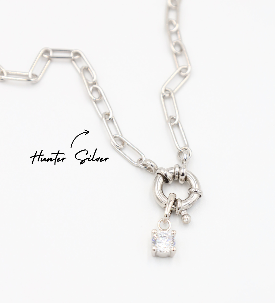 A silver chain necklace featuring the Riley Silver pendant with a sparkling zirconia stone on the Hunter Silver chain clasp.