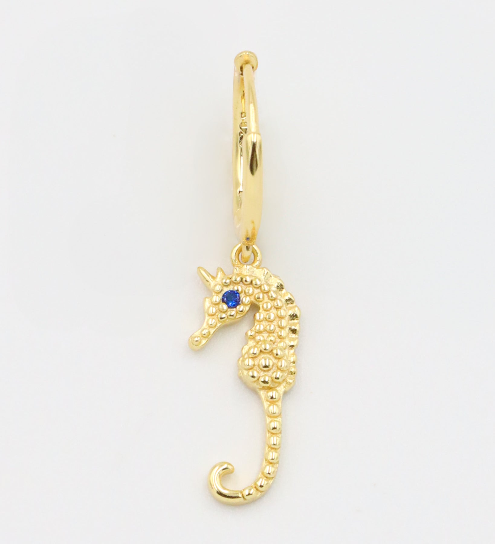 Single left Seahorse Gold earring with a gold-plated seahorse charm and blue zirconia eye.
