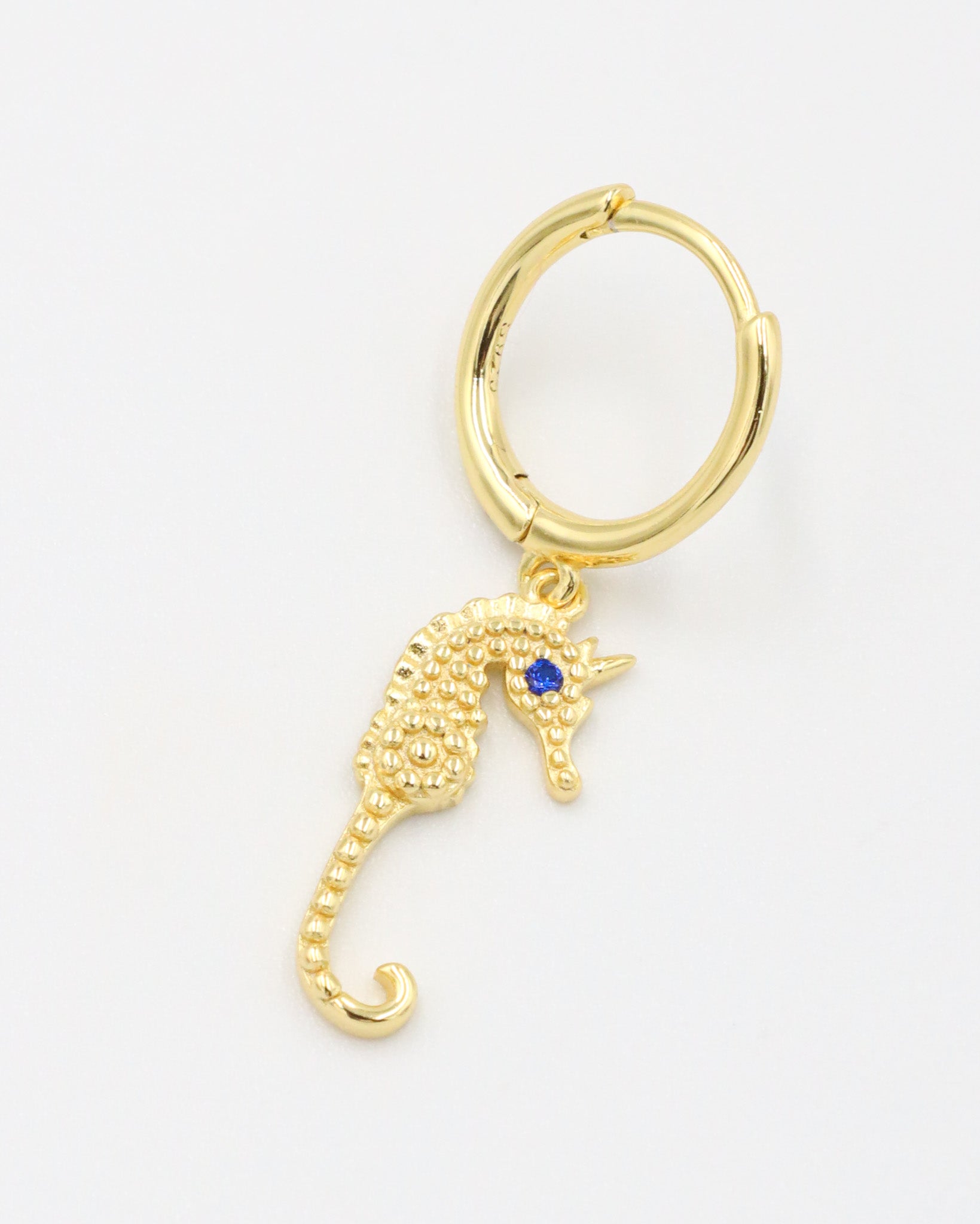 Single right Seahorse Gold earring with a gold-plated seahorse charm and blue zirconia eye.
