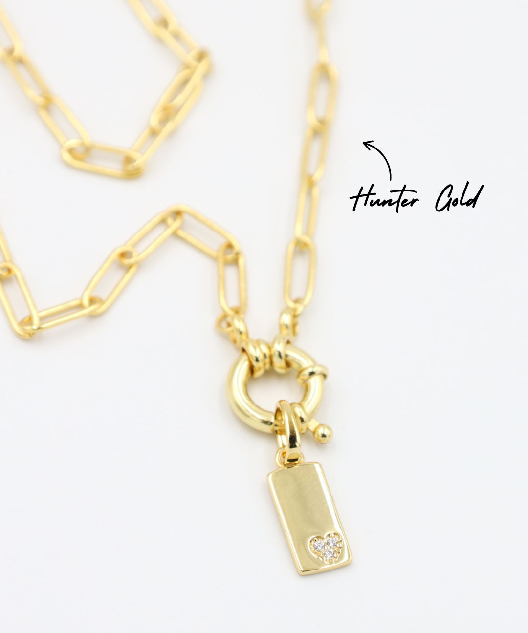 Sophia Gold Pendant with Chain - A gold-plated rectangular pendant attached to a chain, showcasing the small zirconia heart.