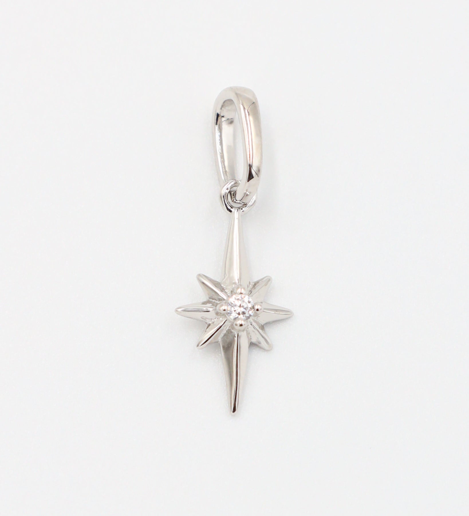 Close-up of a rhodium plated 925 sterling silver star pendant with a zirconia stone.