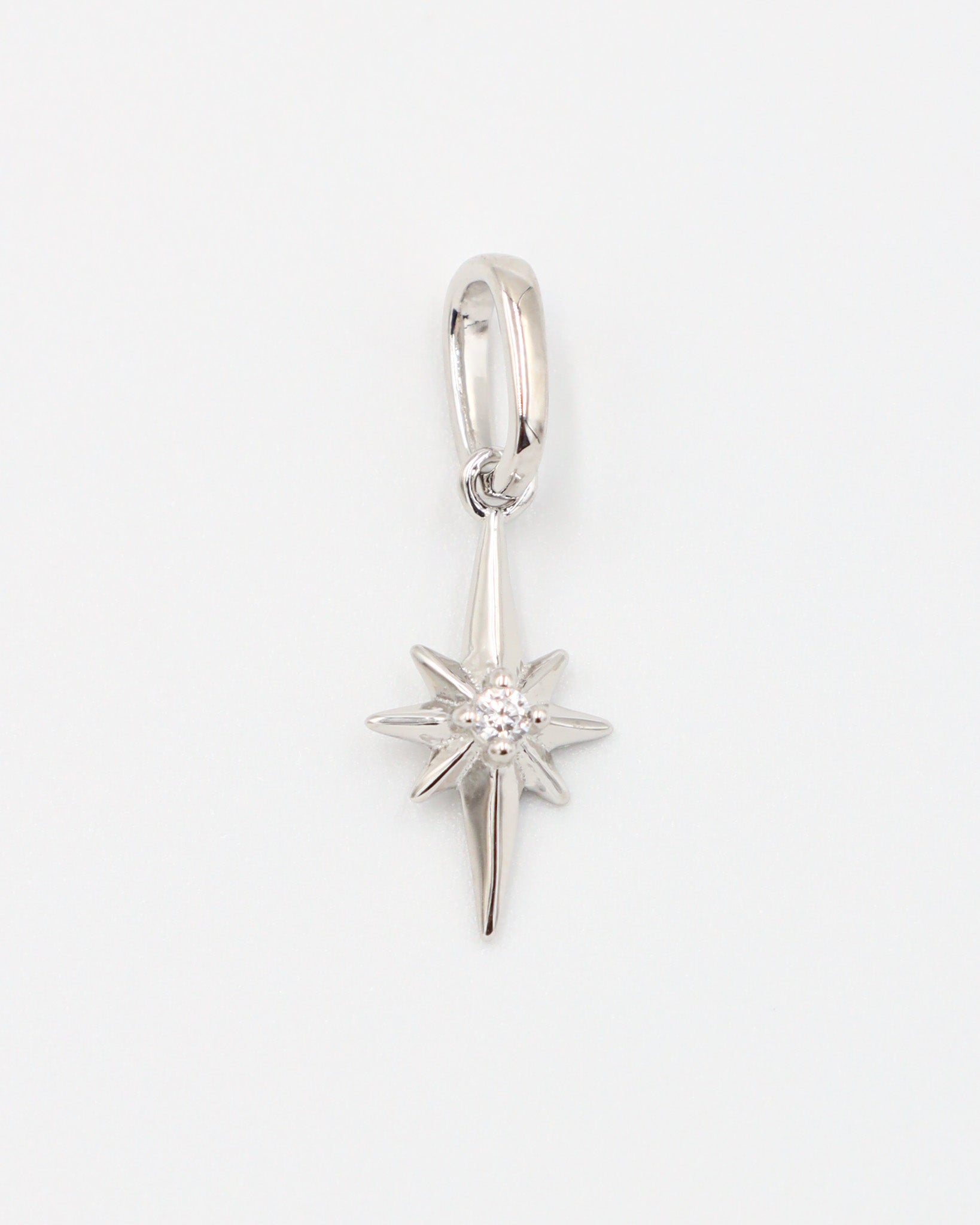 Close-up of a rhodium plated 925 sterling silver star pendant with a zirconia stone.