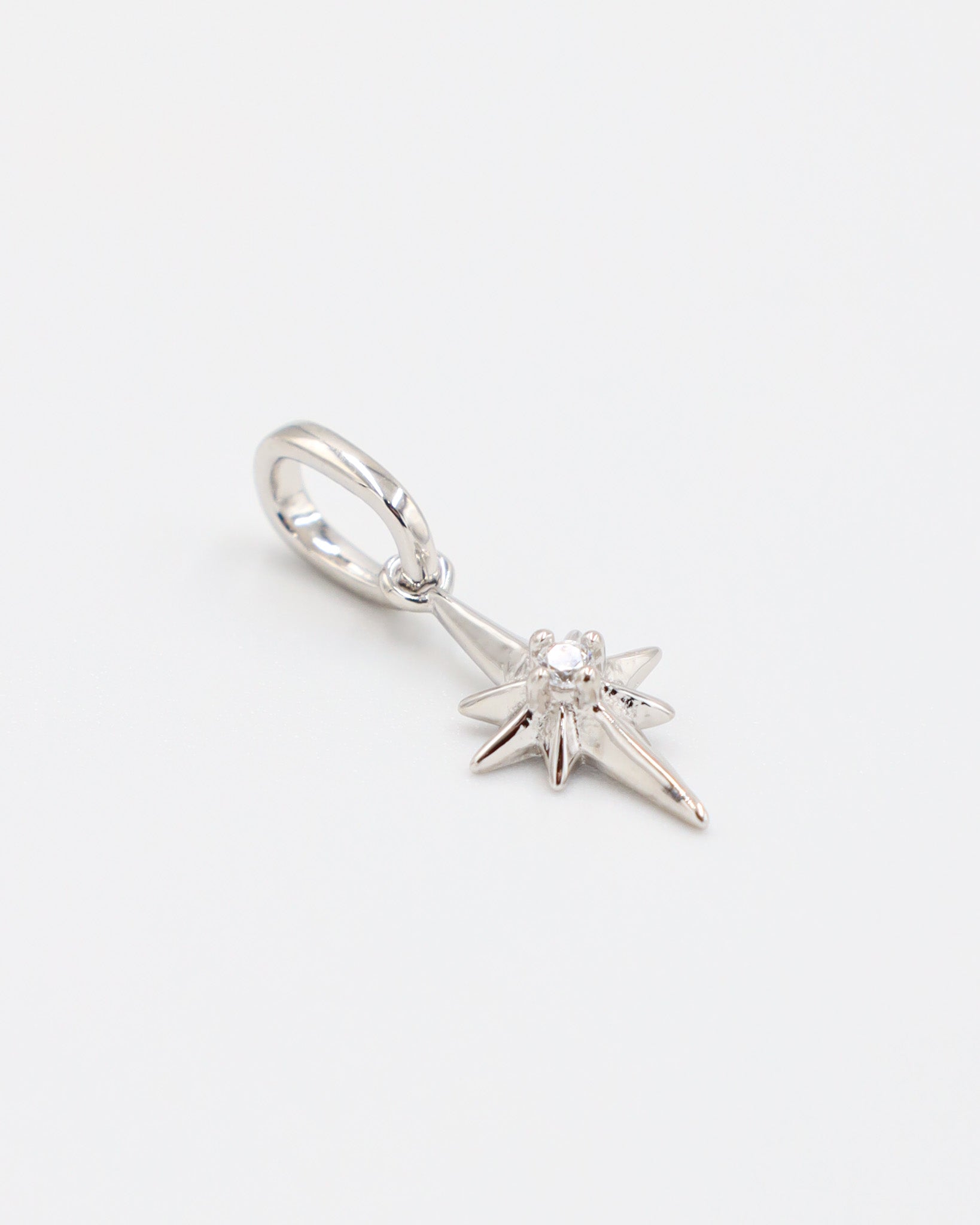 Side view of a rhodium plated 925 sterling silver star pendant featuring a zirconia stone.