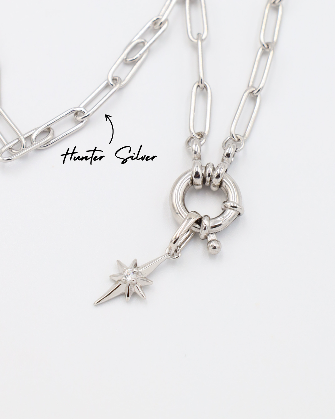 Rhodium plated 925 sterling silver star pendant with zirconia stone displayed on a silver necklace with a toggle clasp.