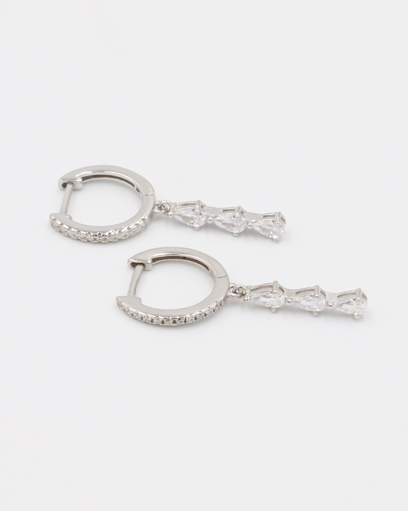 Sterling silver drop earrings featuring four teardrop-shaped cubic zirconia stones.